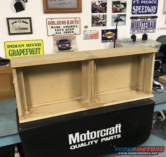 Wooden shelf unit with two compartments sits on a black Motorcraft Quality Parts box