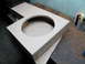 1994 Ford Bronco - A custom-built subwoofer enclosure made of particle board is shown on a workbench.