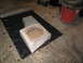 1994 Ford Bronco - A custom subwoofer enclosure is being built on black plastic sheeting in a garage.