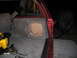1994 Ford Bronco - The interior of a red SUV shows a custom subwoofer enclosure and a spare tire mount, with a yellow power tool visible.