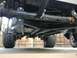 1970 Volkswagen Beetle - A low-angle view shows the complex undercarriage and suspension system of a vehicle with tires.