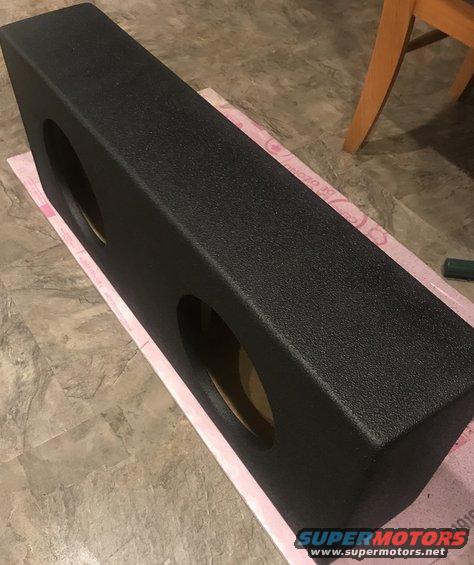 Black dual subwoofer enclosure with two circular openings
