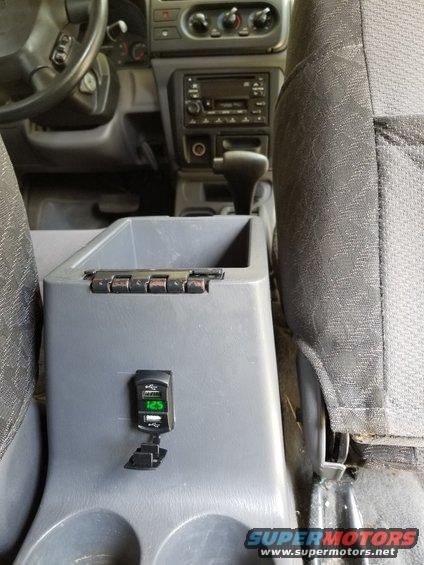 This dual USB power socket is wired to the cigar lighter.  There's also an FM modulator with iPhone fire connector up front.