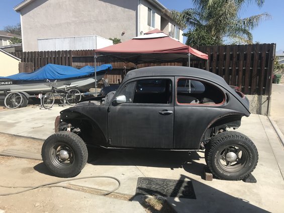 Black Volkswagen Beetle with off-road tires, side view