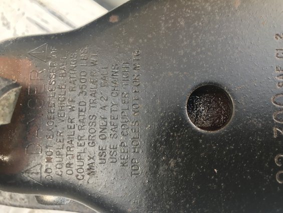 Trailer coupler rating plate with warnings about exceeding coupler or trailer weight ratings