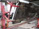 1962 Ford Galaxie - Car's undercarriage is visible while it's raised on jack stands for maintenance.
