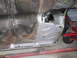 1962 Ford Galaxie - The underside of a vehicle shows significant rust and evidence of bodywork on the floor pan and frame.