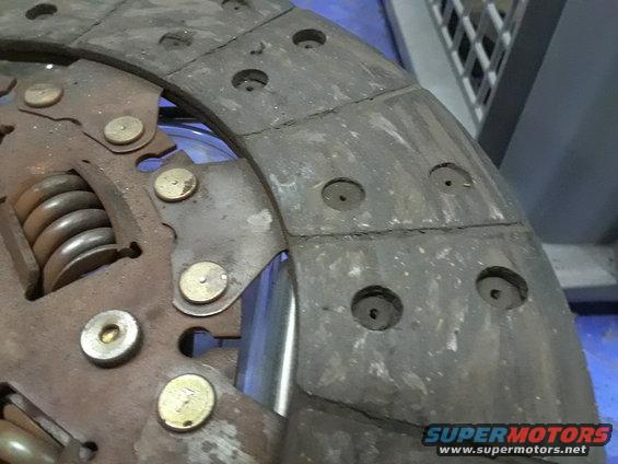 close-up of a worn clutch disc with springs and rivets visible