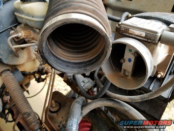 Apparently, the air filter was not installed properly at some point, allowing a LOT of dust through the MAF & into the TB.  I washed & scrubbed the hose, but the dust has stained it permanently.  The MAF seems to be working, so it's safer NOT to mess with it.