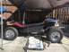 1970 Volkswagen Beetle - Custom dune buggy with flame decals, parked under a canopy.