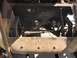 1970 Volkswagen Beetle - Close-up view of a car's front chassis and engine bay, showing mechanical parts and rusty metal.