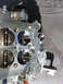 1977 Ford Ranchero - Carburetor part detail, showing internal mechanisms and metal construction.