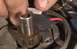 1971 Ford Ranchero - Close-up of a vehicle's distributor cap and rotor assembly, with a finger interacting with the rotor.