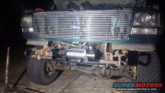 kimg0321.jpg i welded 6 inch pieced of L steel to the front of the frame this gave me a good strong way to mount the winch in the front. i drilled 2 1/2 inch bolts on each side. i did trim some of the very front frame rails in order to get a flat surface to weld to