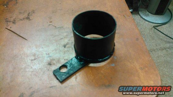 Black metal part with a mounting tab, likely a drive shaft component
