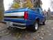 1994 Ford F-150 - Blue Ford pickup truck parked outdoors with autumn leaves on the ground.