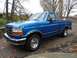 1994 Ford F-150 - This blue 1994 Ford F-150 pickup truck is shown from a 3q-front angle.