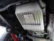 1994 Ford F-150 - Underneath view of a vehicle's transmission pan, showing its ribbed design and a visible bolt head.