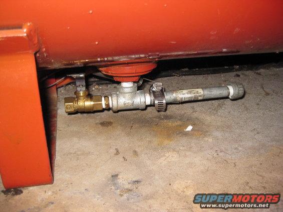 Air compressor drain valve assembly with brass ball valve and metal pipe secured by hose clamp