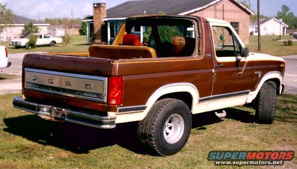 Brown and white 1980 Ford Bronco, rear three-quarter view, with top removed