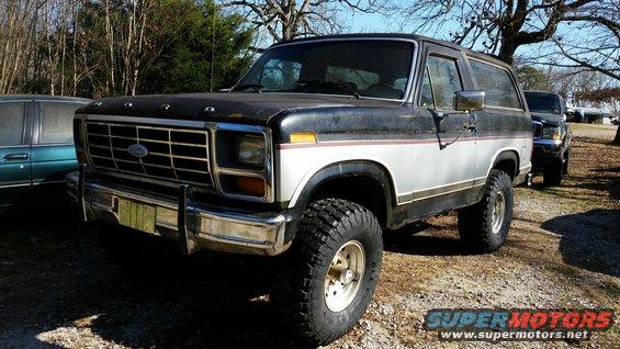 1986 Ford Bronco with aftermarket wheels and tires, parked outdoors