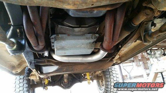 Underside view of vehicle with exhaust headers and transmission pan