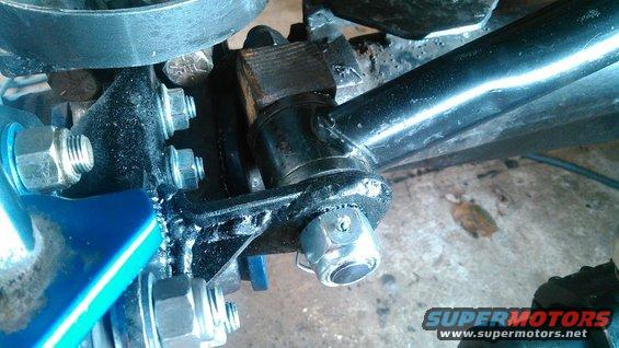 Front axle suspension components with visible bolts and metal brackets