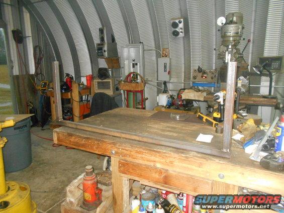 Workshop with a workbench, milling machine, drill press, and various tools