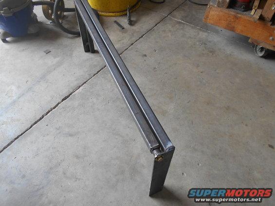 Metal bracket with a hinge and bolt on a concrete floor