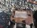 1992 Ford Bronco - A rusty transfer case part features a caution label detailing installation procedures and fluid requirements for a PTO drive.