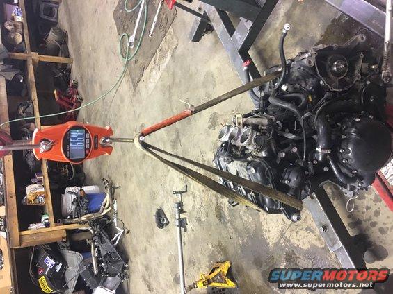 Engine on a hoist scale reading 166.4 lbs
