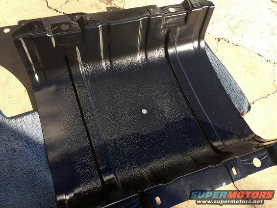 Black metal skid plate with mounting holes and textured surface