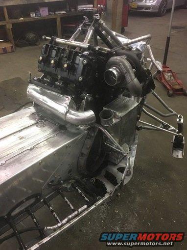 Custom snowmobile chassis with a V8 engine and turbocharger installed