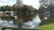 2006 Honda RANCHER - A residential street is submerged in floodwaters, with homes and vehicles underwater.
