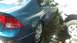 2006 Honda RANCHER - Blue 2006 Honda Civic sedan parked beside a white truck with water on the ground.