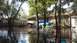 2006 Honda RANCHER - A flooded residential area with houses and trees submerged in water.