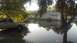 2006 Honda RANCHER - A silver pickup truck sits in a flooded residential area with houses and trees reflected in the water.