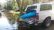 2006 Honda RANCHER - A white SUV is parked in floodwaters with a blue kayak loaded in the back.