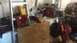2006 Honda RANCHER - A disorganized garage scene contains a ladder, washing machine, and numerous tools, suggesting a storage or workshop area.