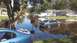 2006 Honda RANCHER - A suburban street is flooded, with several vehicles partially submerged in the brown water.