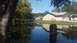 2006 Honda RANCHER - Flooded residential area after heavy rain, with houses and trees reflected in the water.