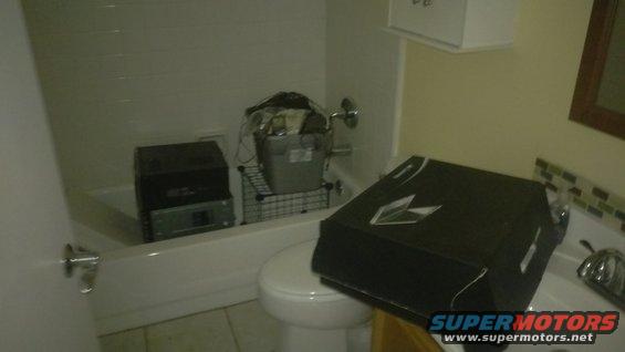 Bathroom scene with boxes in bathtub and on sink