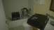2006 Honda RANCHER - A bathroom scene shows various boxes and a bucket placed in the bathtub and on the sink counter.