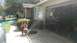 2006 Honda RANCHER - A pressure washer sprays water in front of a residential garage, with a kayak and a car visible in the background.