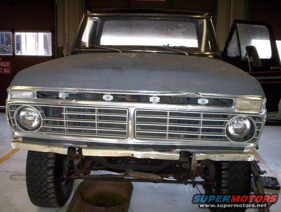 1978 Ford Bronco front end with grille and headlights visible, hood is gray primer