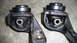 1993 Mazda MX-3 - Close-up of two engine mounts, possibly for a Mazda MX-3, showing stamped markings.
