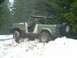 1990 Ford Bronco - A man drives a classic Ford Bronco through a snowy, wooded area.