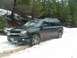 1990 Ford Bronco - A black Chevrolet Trailblazer SUV is stuck in a snowy, wooded area.
