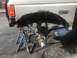 1989 Ford Bronco - Ford F-250 Lariat rear axle assembly undergoing work, supported by jack stands.