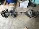 1989 Ford Bronco - A heavy-duty Ford Dana 60 axle assembly is shown resting on the floor, likely for a rebuild or modification.
